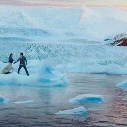 Couple dancing on floating iceberg.