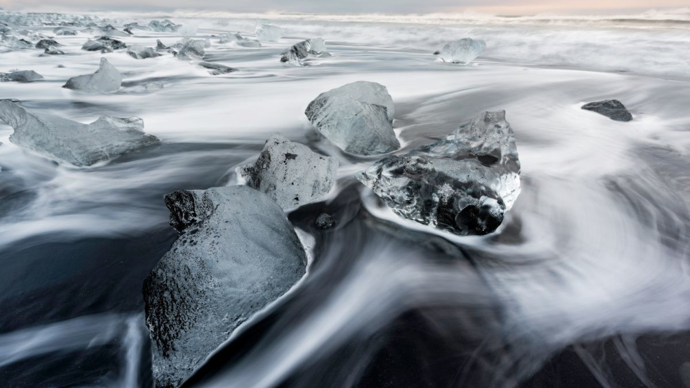 Small icebergs on a black sand beach