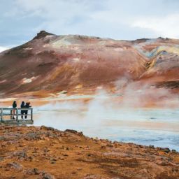Picture of red-ish Mars alike landscape with geothermal steam and boiling water.