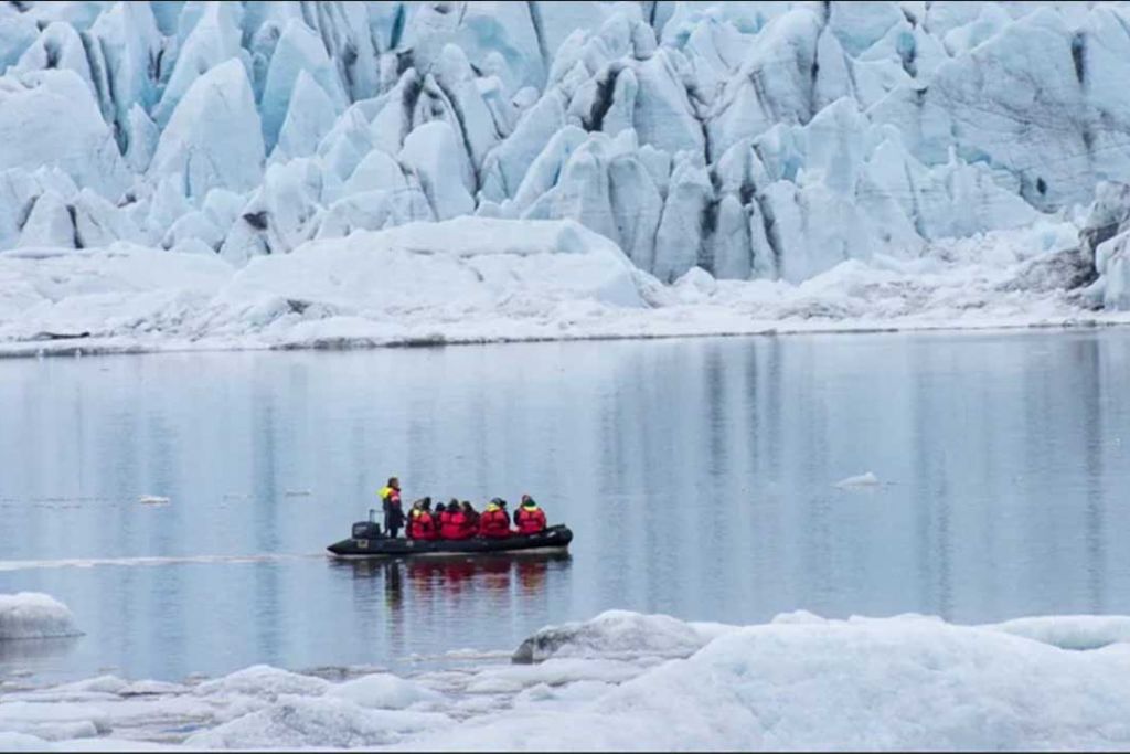 Tourists on a boat on glacial waters.