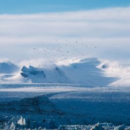 Breidamerkurjökull glacier with snowy mountains in the background.