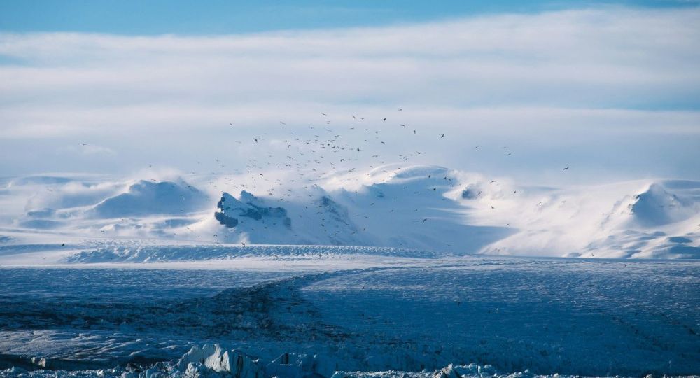 Breidamerkurjökull glacier with snowy mountains in the background.
