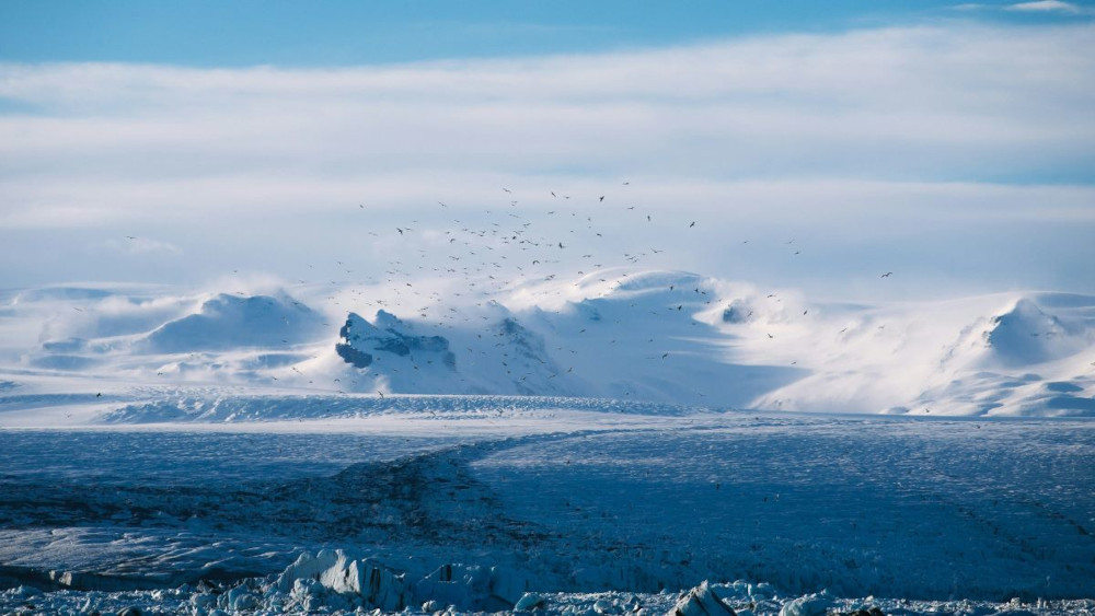 Breidamerkurjökull glacier with snowy mountains in the background.