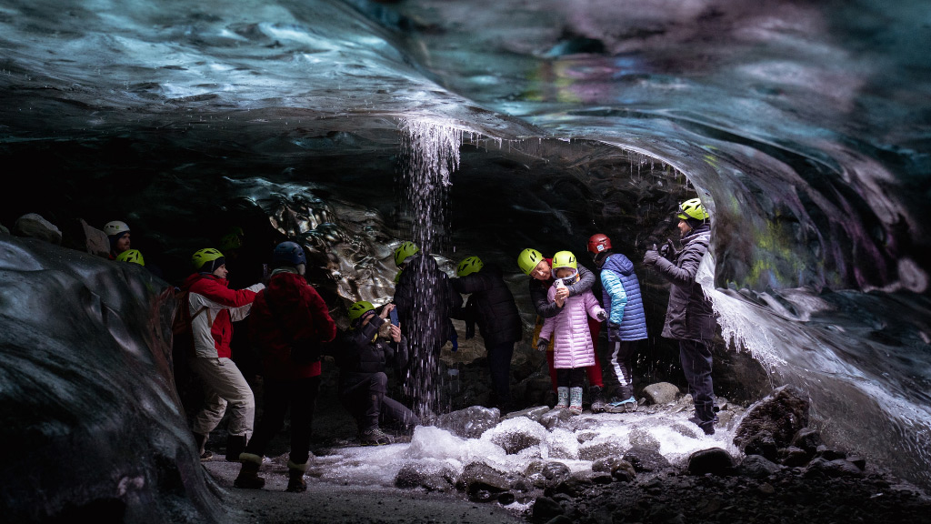Why-Iceland’s-Ice-Caves-are-Changing_-the-Impact-of-Melting-Glaciers---Pic-5 A group of people inside an ice cave located in Vatnajökull glacier with melt water running down into to cave.